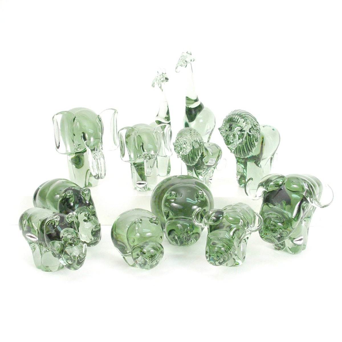 Assortment of green-tinted glass elephant figurines with varied poses