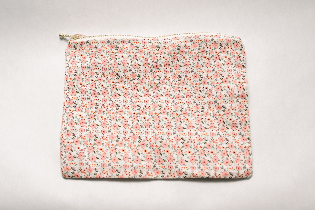 Peach floral ruffle zipper pouch with smooth front and top zipper
