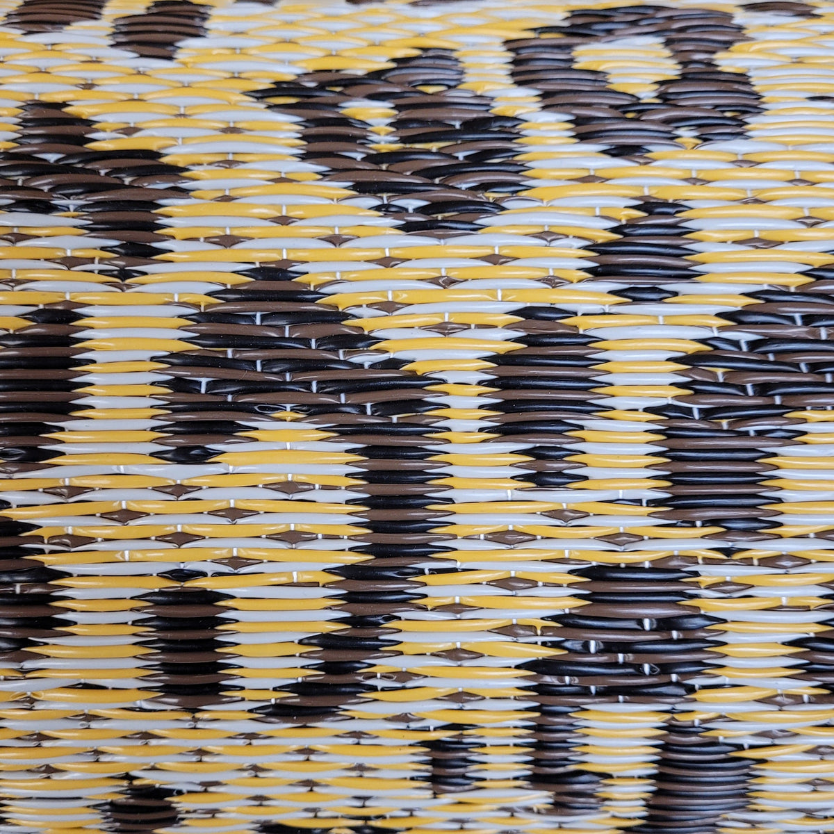 Woven leopard-print natural rug close-up with light beige and dark brown pattern