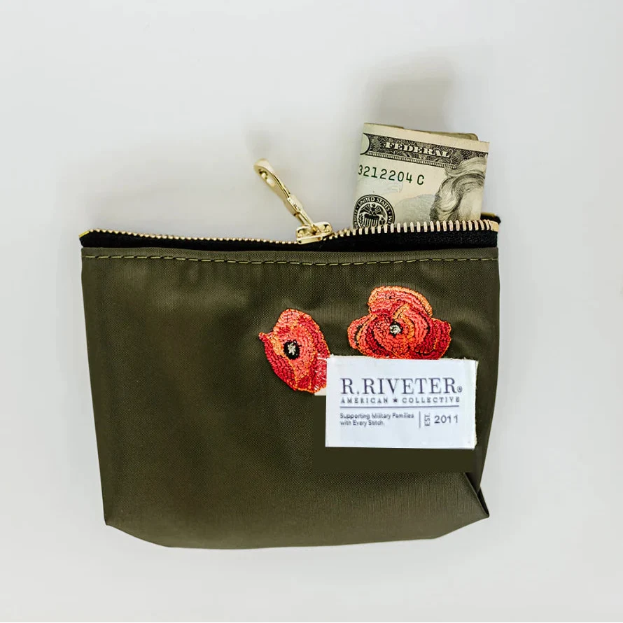 Lucy mini zipper pouch in fatigue green with floral patch, gold zipper, cash peeking inside