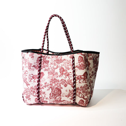 Printed tote bag with black top trim, red-and-white lion patchwork, double handles