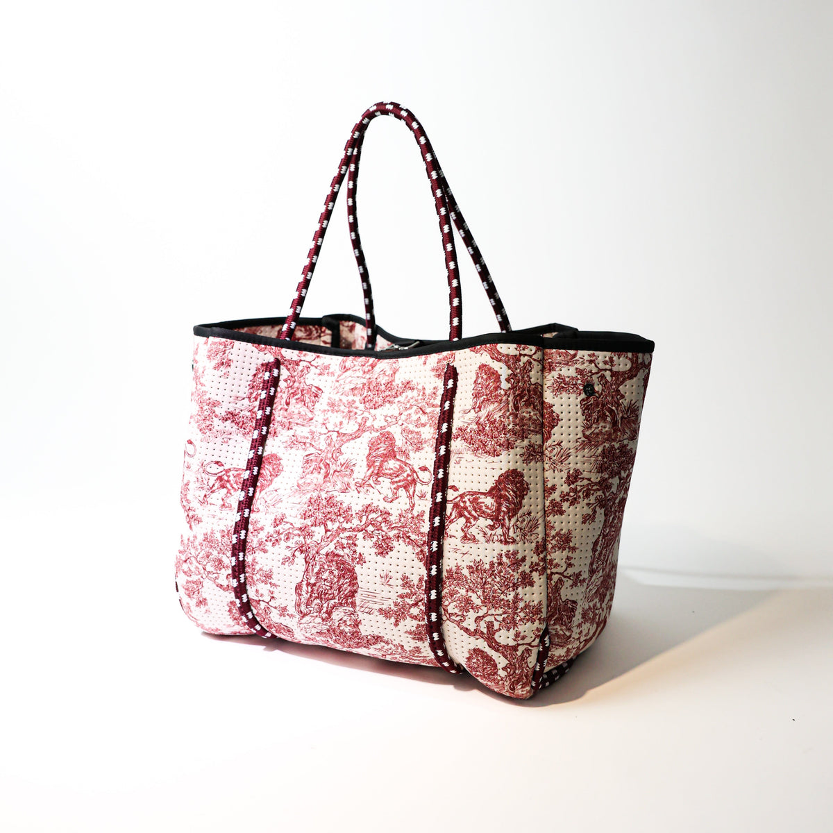 Red-and-white toile tote bag with black straps and trim, structured sides, wide open top