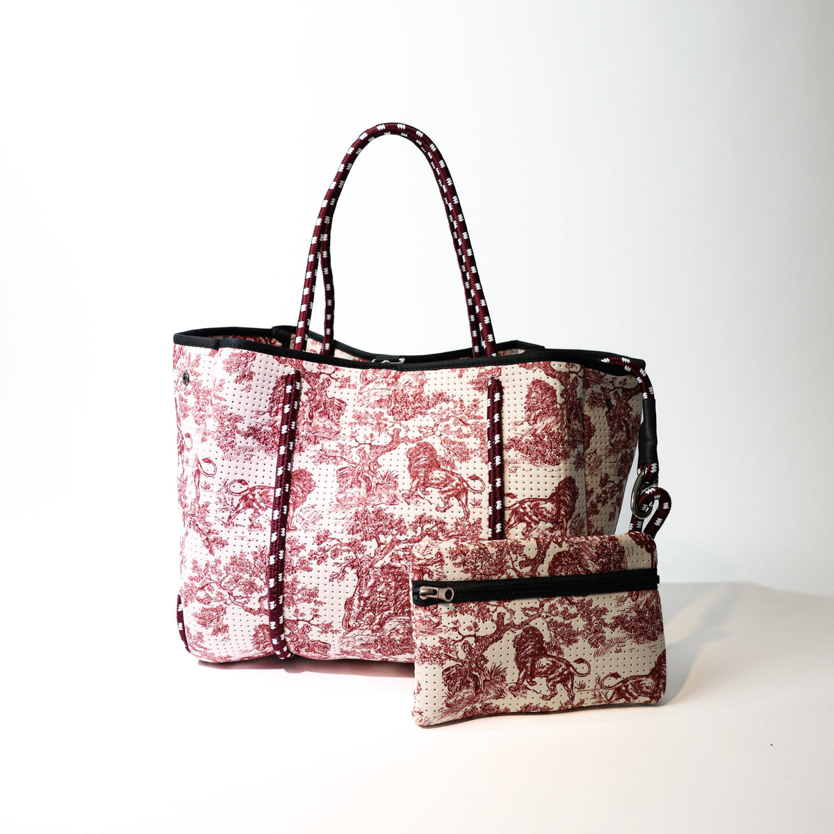 Printed tote bag with side zip pouch, black trim, red-and-white lion pattern, double handles
