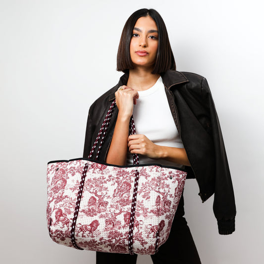 Red-and-white printed tote bag with black double handles, open top, central panel