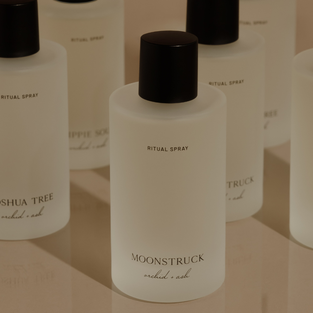 MOONSTRUCK ritual spray bottle with black cap, with several bottles in background