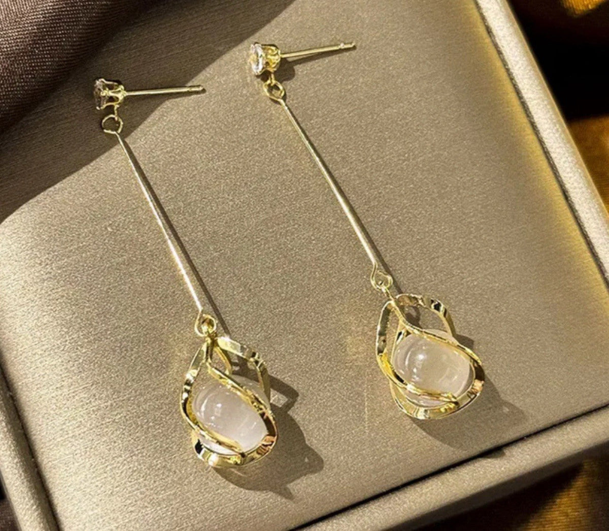 Gold-plated dangle earrings with oval cat-eye stones and crystal accents