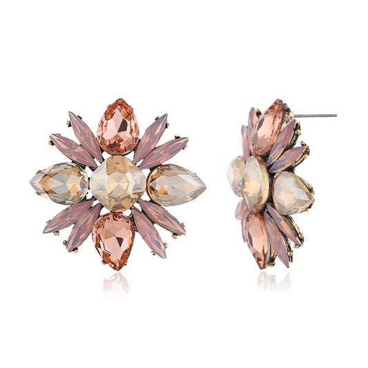Large flower-shaped stud earrings with pink cubic zirconia and clear stones, prong set