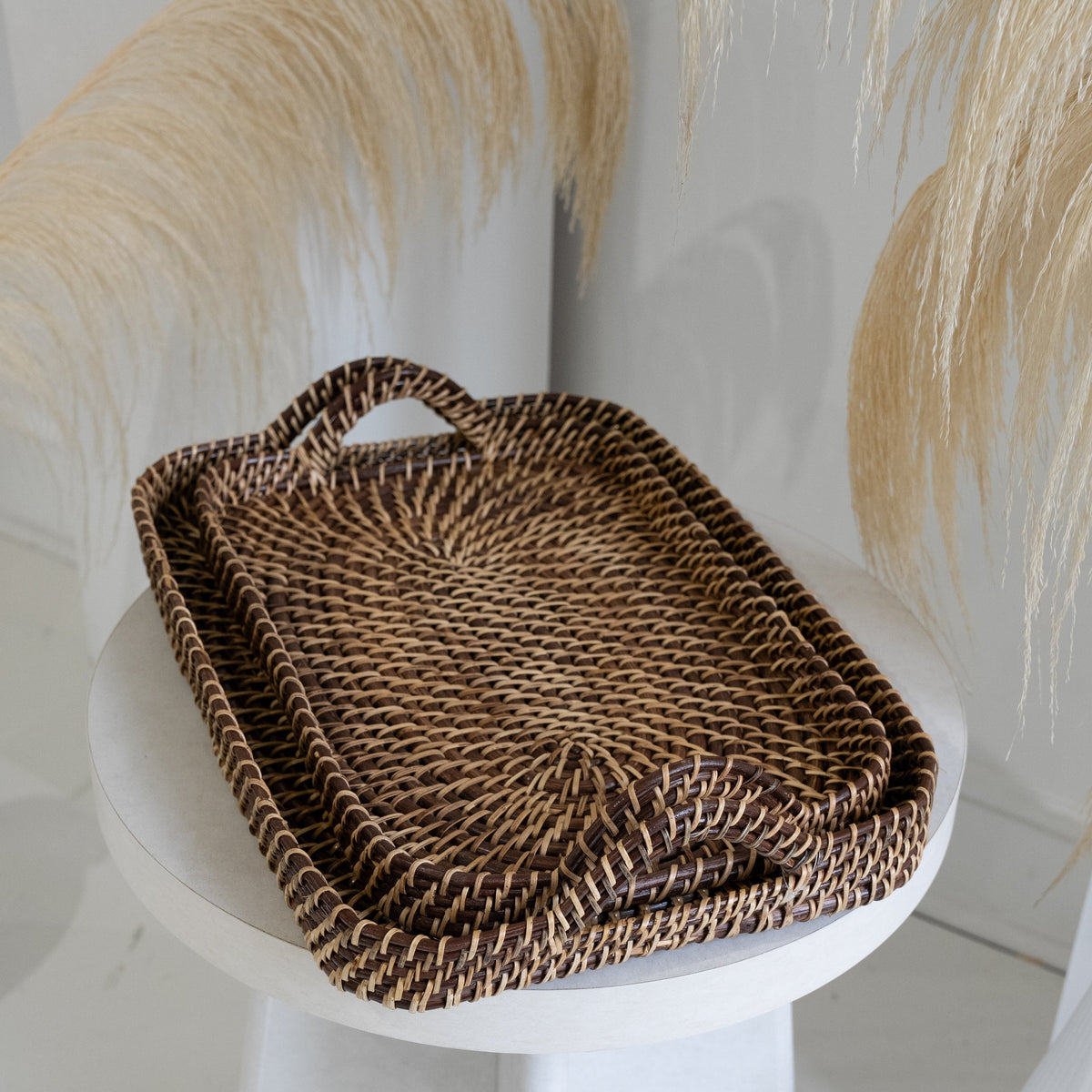 Woven rectangular tray, brown and natural, with raised rim and rope side handles