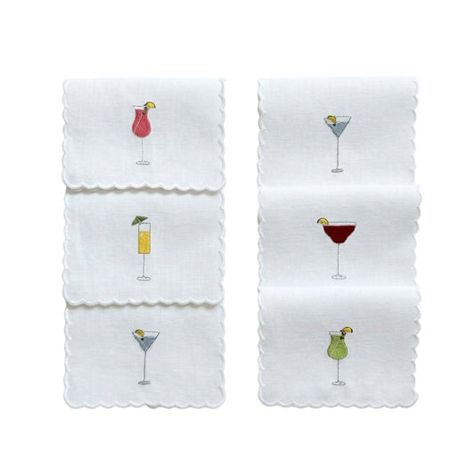 Set of 6 embroidered cocktail napkins, white fabric with scalloped edges and drink icons.