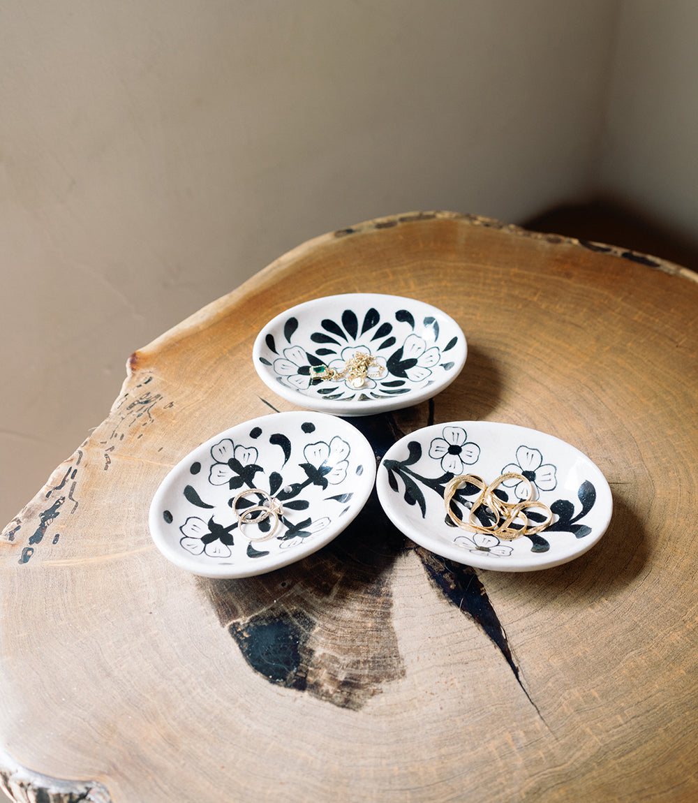 Set of hand-painted ceramic trinket dishes with blue floral motifs, oval bowls with gold details