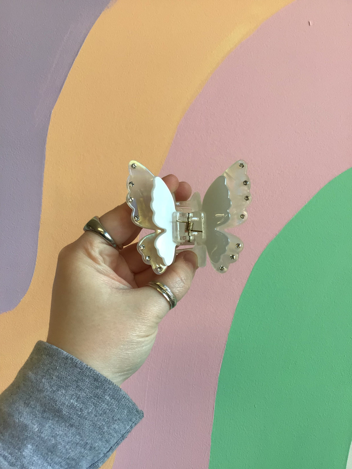 Butterfly hair claw with pale blue-and-green wings, jeweled edge, silver comb clip