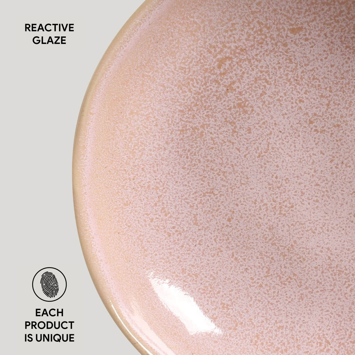 Pink speckled glazed ceramic pasta plate, close-up on curved surface