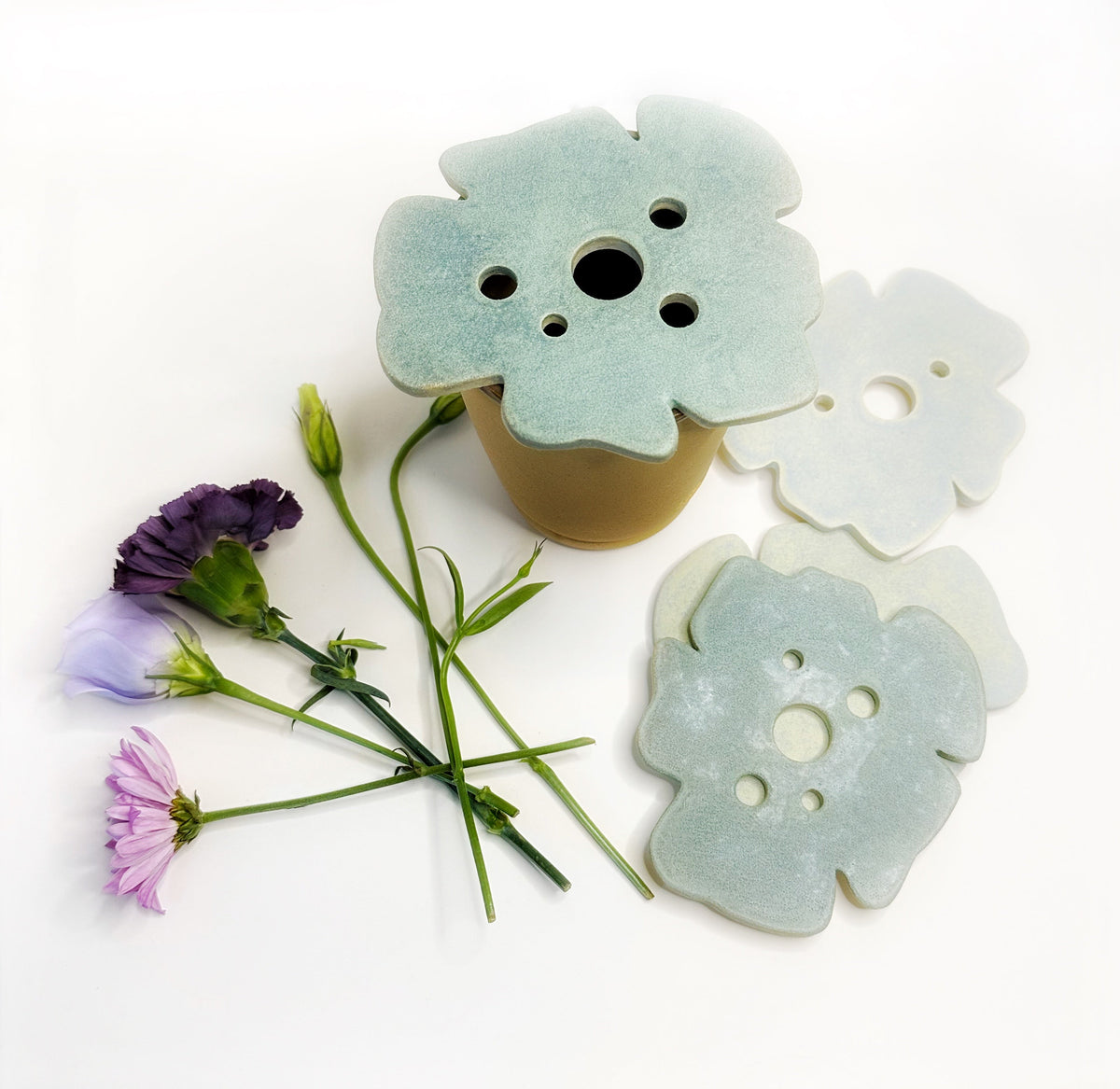 Set of frog-shaped decor pieces in light blue and cream, with button-like holes