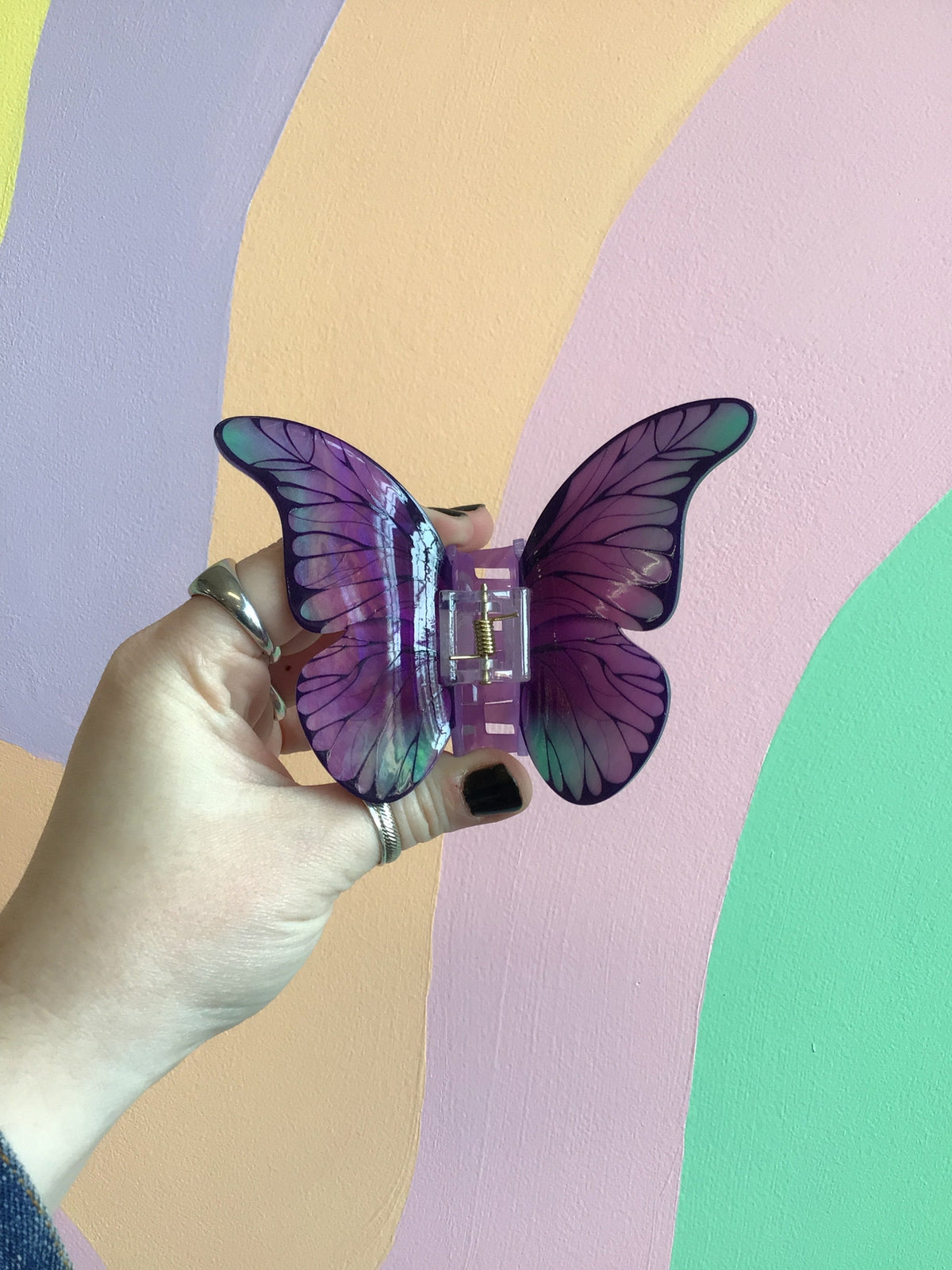 Purple butterfly hair claw with multitone wings and a central metal clasp