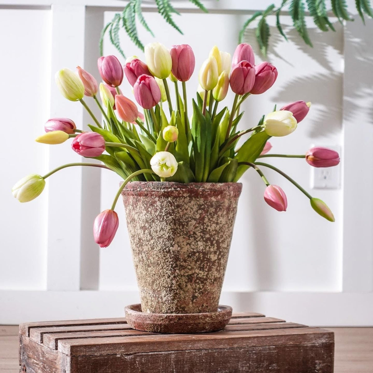 Pink and yellow tulip bouquet with green stems and leaves