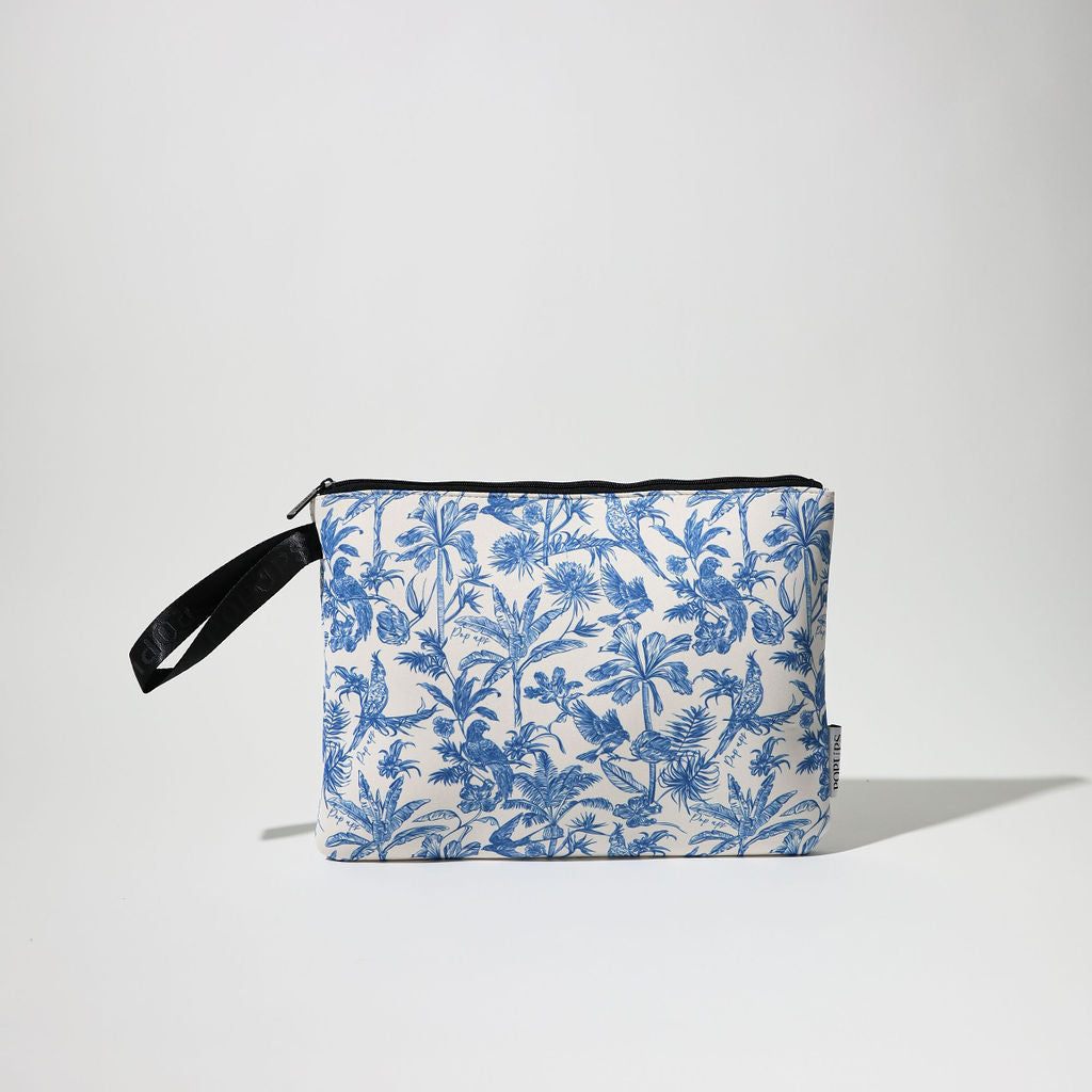 Blue and white toile laptop sleeve with black strap and zipper closure