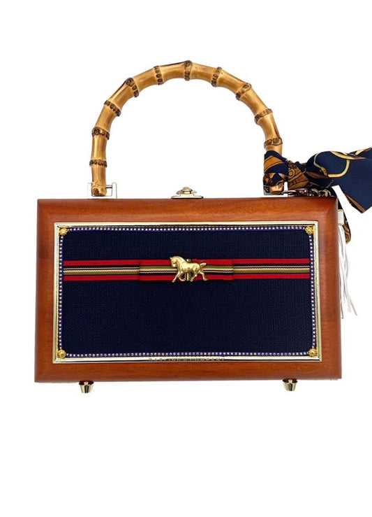 Brown toiletry bag with bamboo handles, navy striped front, gold horse emblem, brass hardware