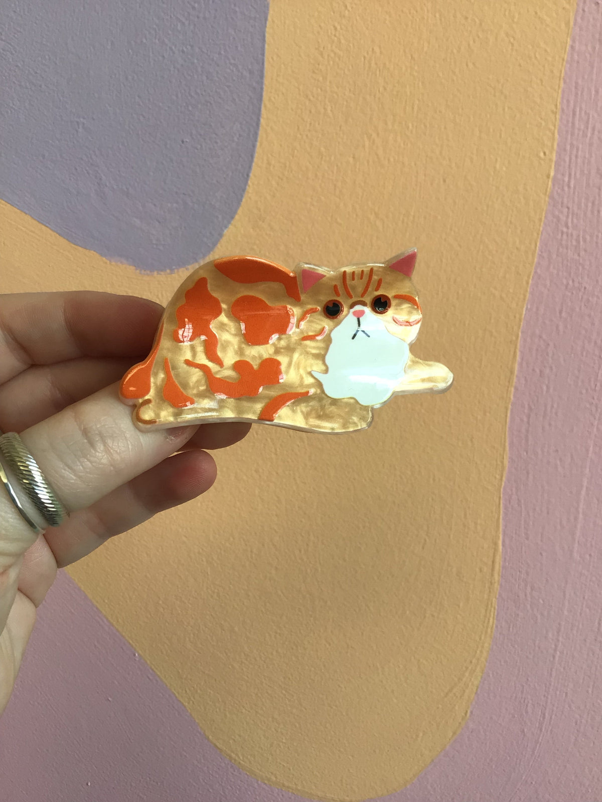 Orange and white cat hair claw clip with curled tail and whiskers