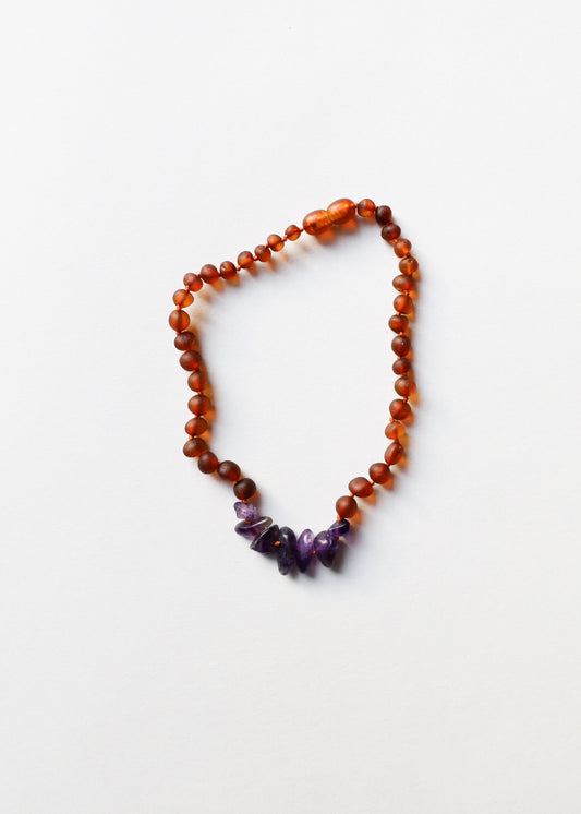 Raw amber bead necklace with small purple amethyst tips, teardrop shape.