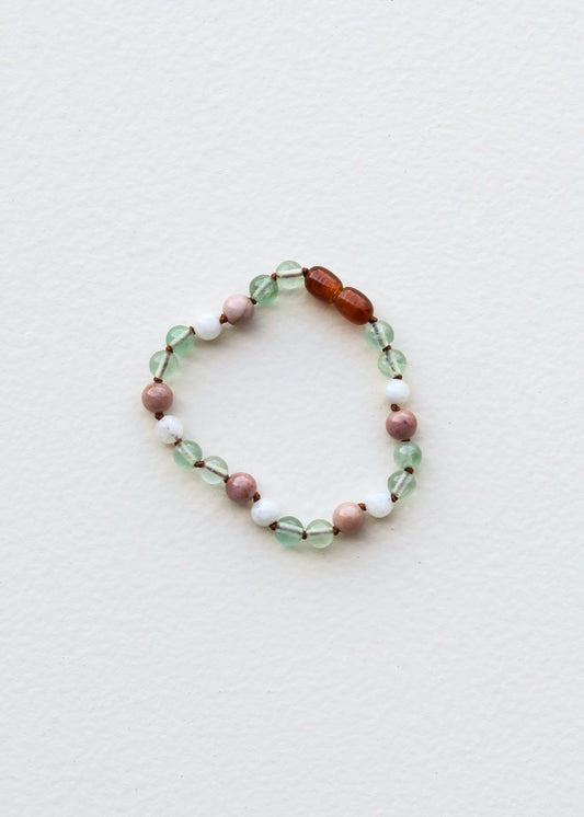 Beaded gemstone bracelet with green, pink, white, and amber faceted round beads