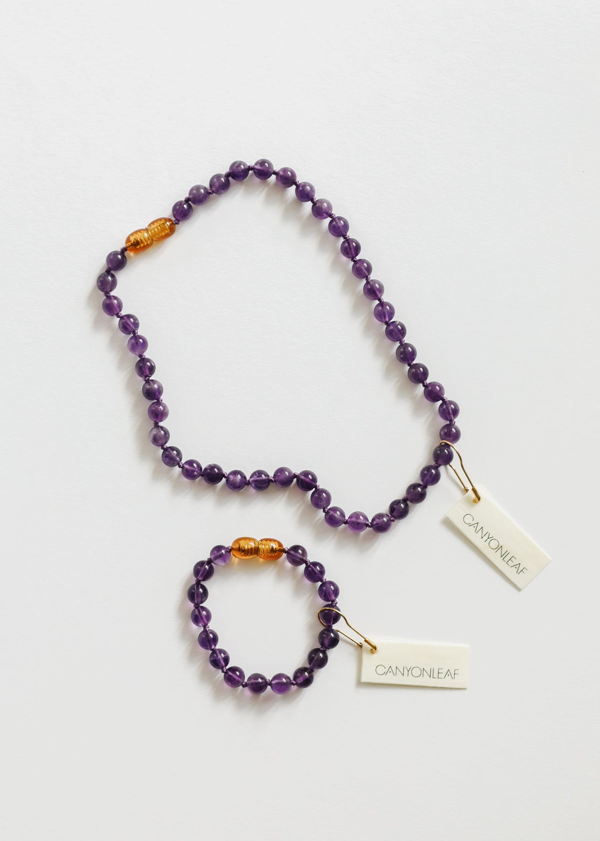 Amethyst bead necklace with amber beads, plus small bracelet and hanging brand tags