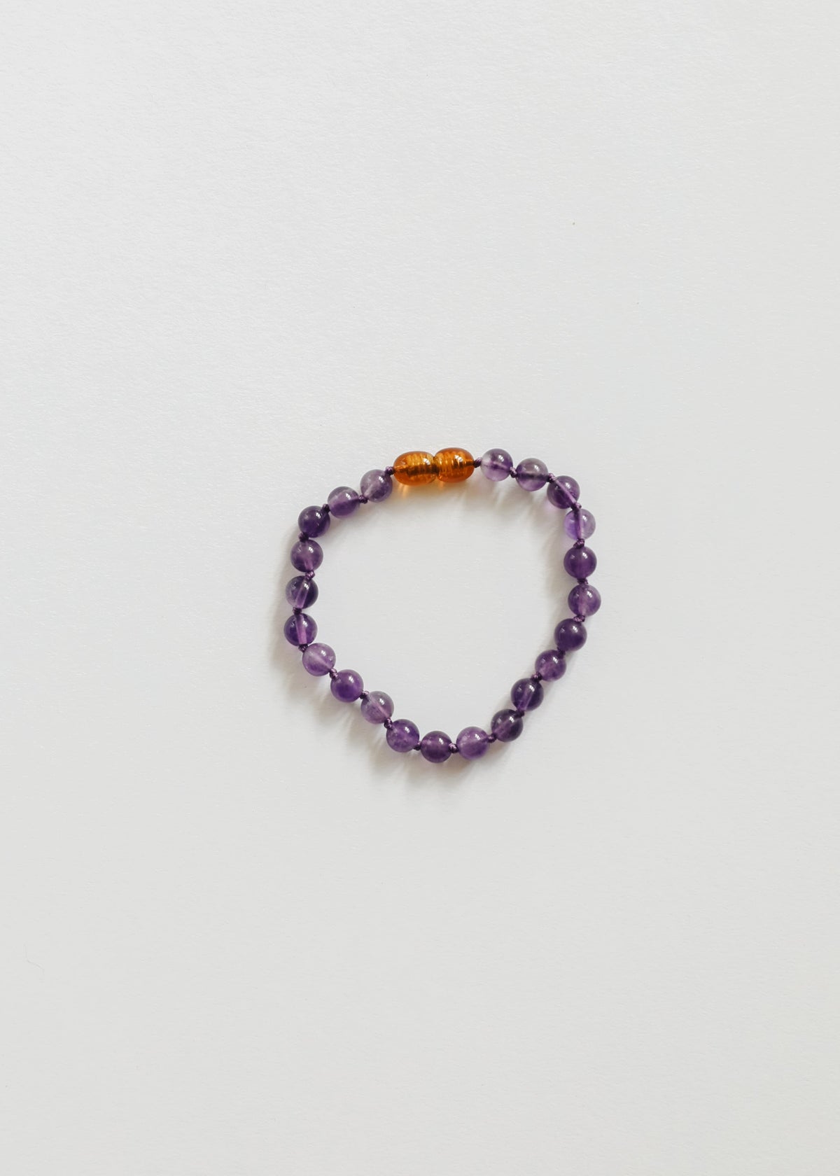 Amethyst bead bracelet with two gold spacer beads