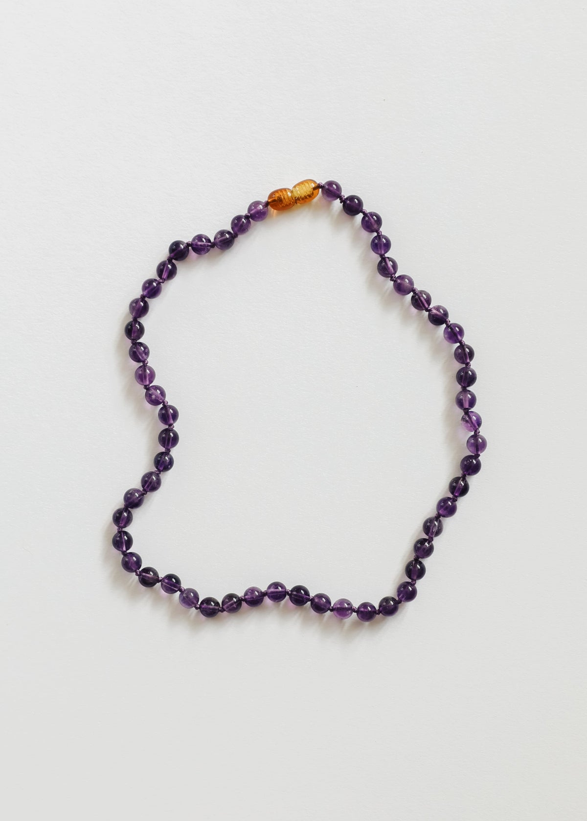 Amethyst bead necklace with purple round stones and amber accent beads