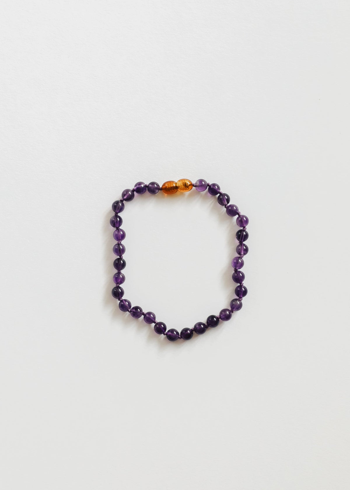 Amethyst bead bracelet with central gold spacer bead