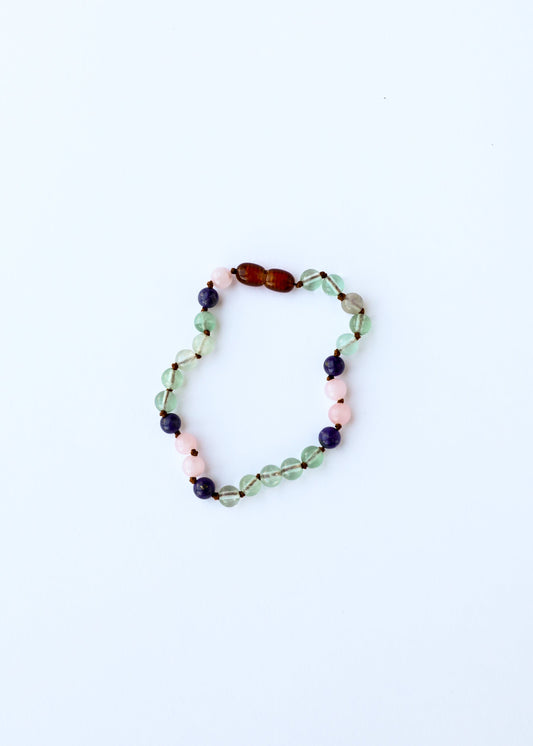 Beaded gemstone bracelet featuring mixed green, rose, and dark blue stone beads