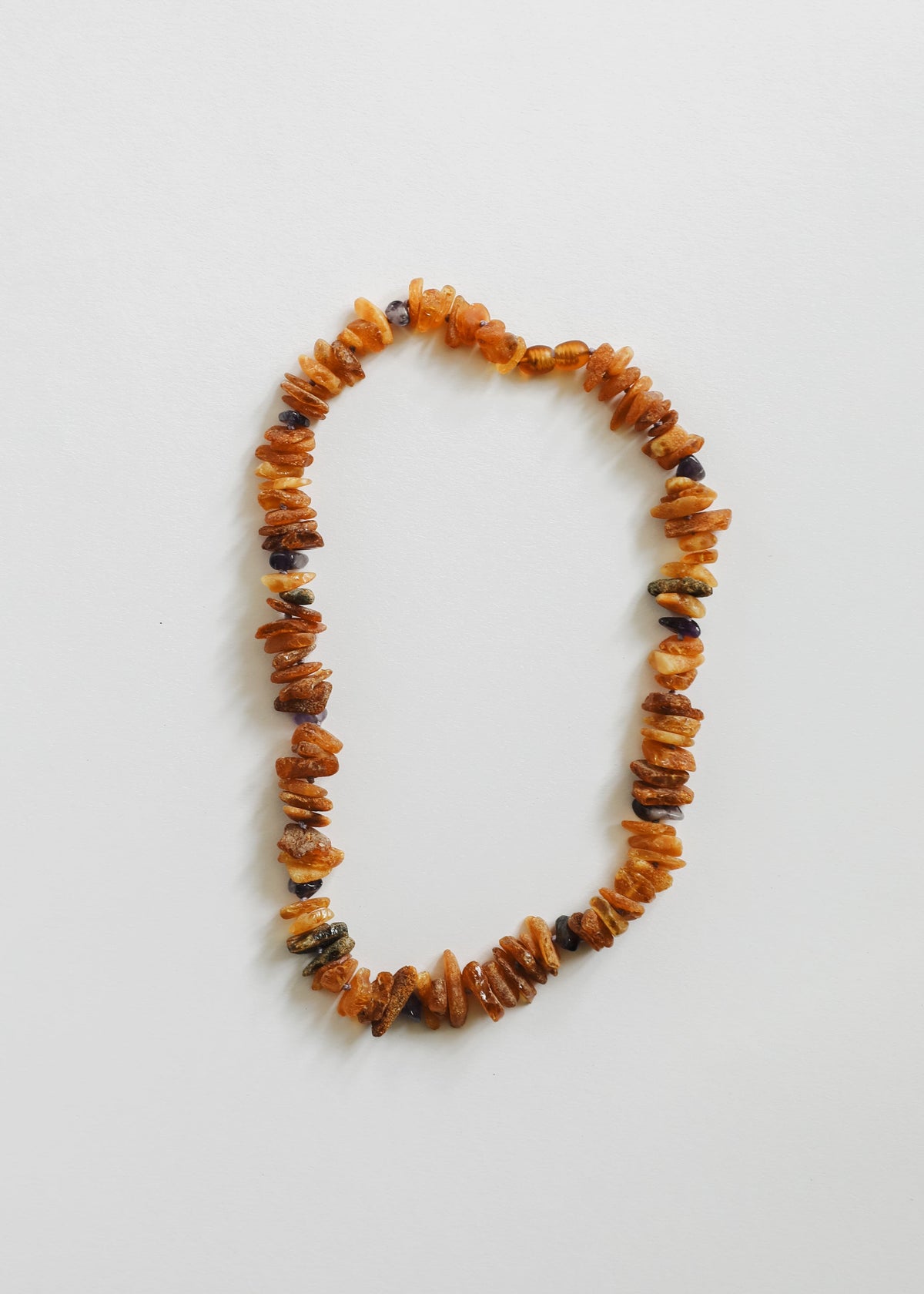 Raw amber and amethyst pet bead necklace with orange amber chips and dark rough stones