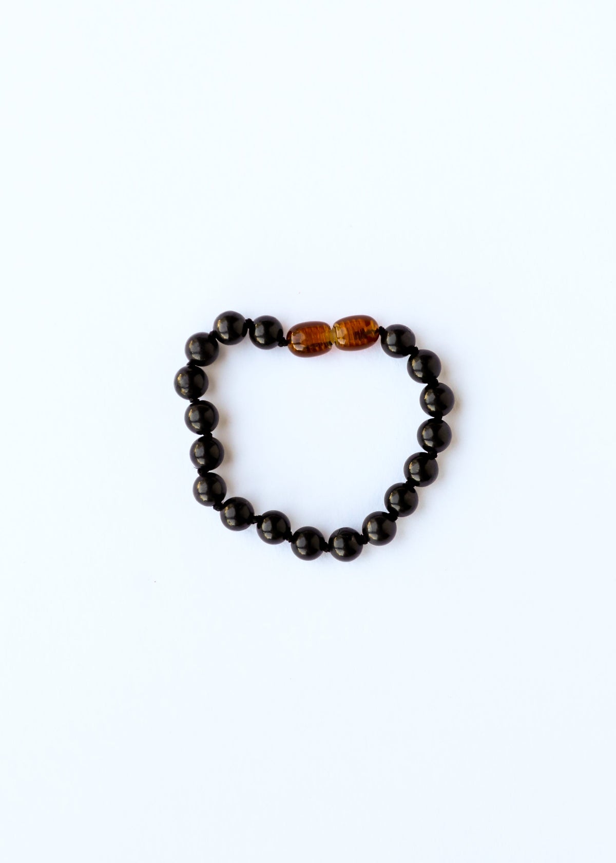Black shungite bead bracelet or anklet with amber-toned center bead detail