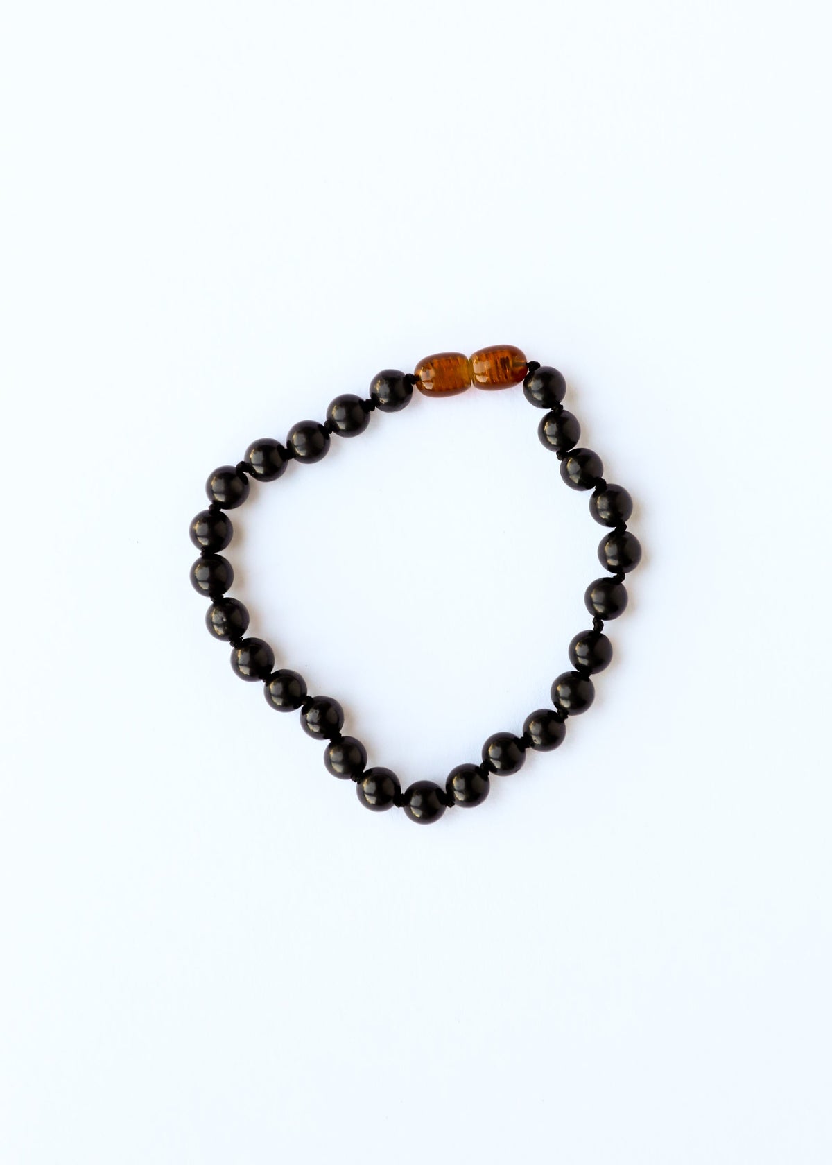 Black shungite bead bracelet or anklet with amber-toned focal beads at center