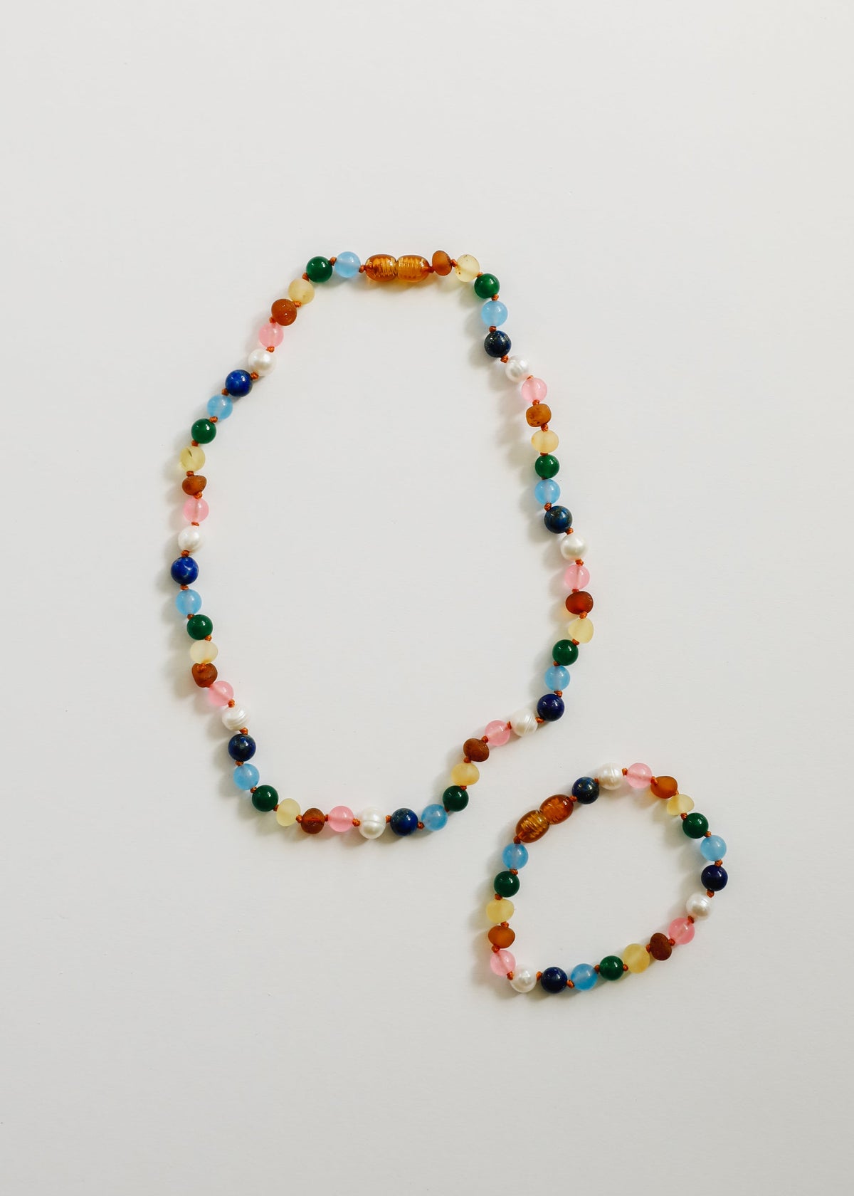 Multicolor beaded necklace with matching bracelet, pearl-white bead details