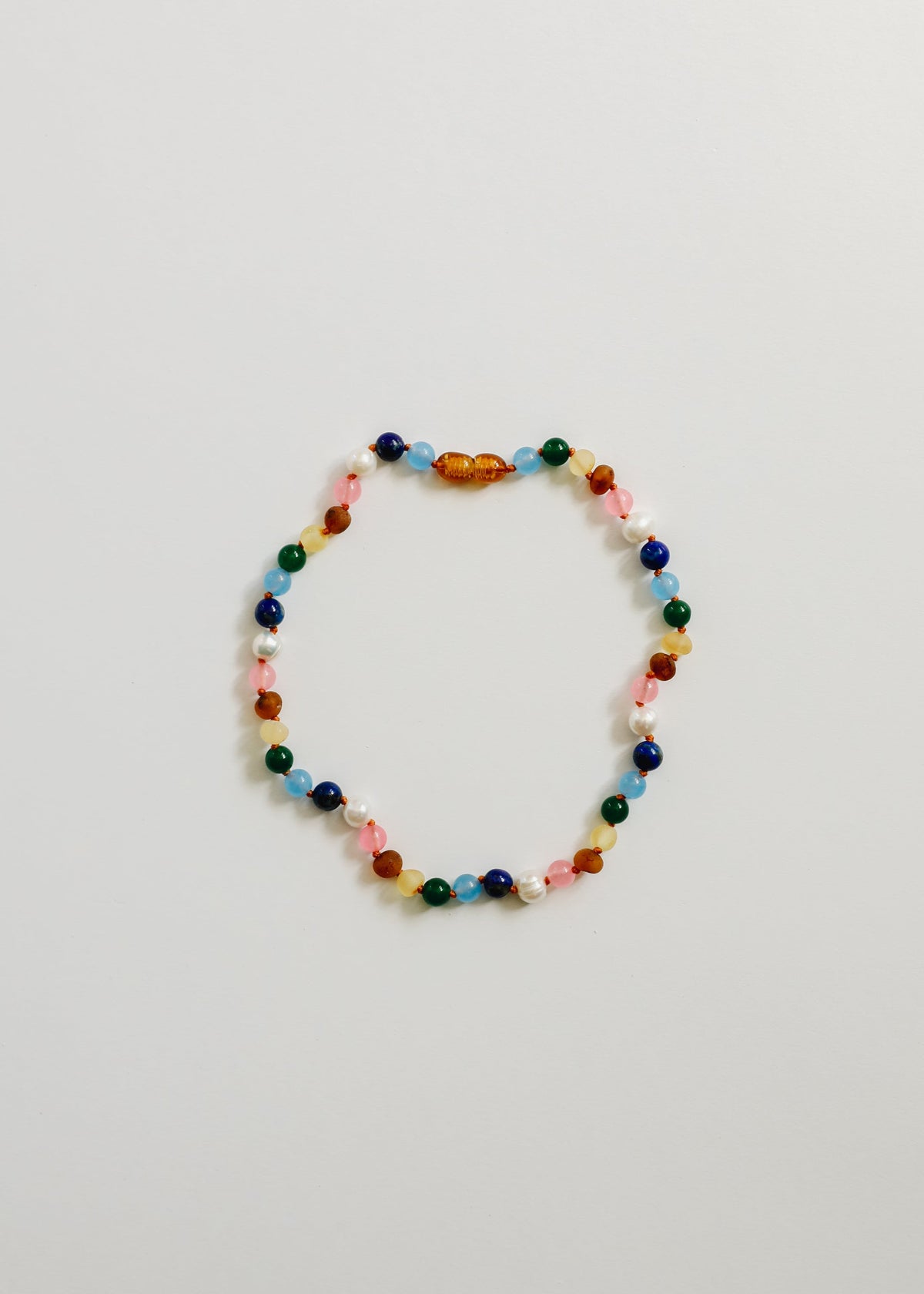 Multicolor gemstone beaded necklace with amber-toned clasp center bead