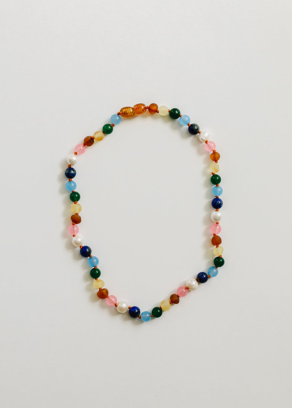 Multicolor beaded necklace with amber-toned beads and pearl-white accents