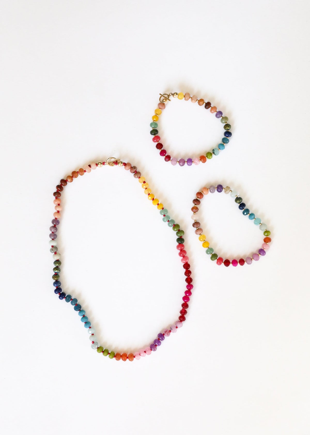 Set of multicolor gemstone beaded necklaces with gold toggle clasp, stacked view