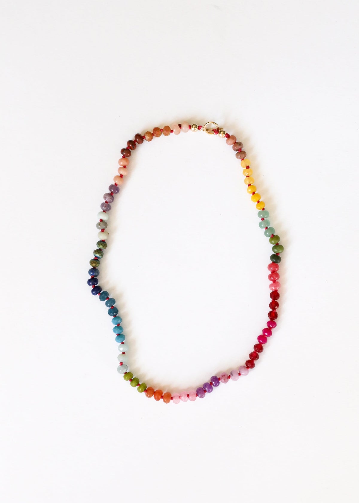 Multicolor gemstone beaded necklace with gold toggle clasp, oval bead pattern
