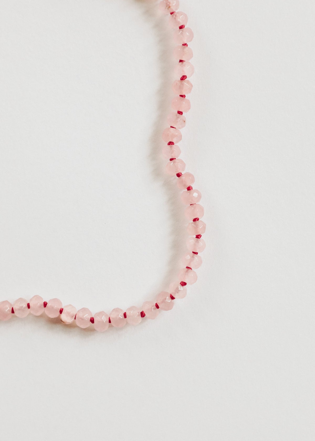 Pink gemstone beaded bracelet, close-up with gold toggle detail