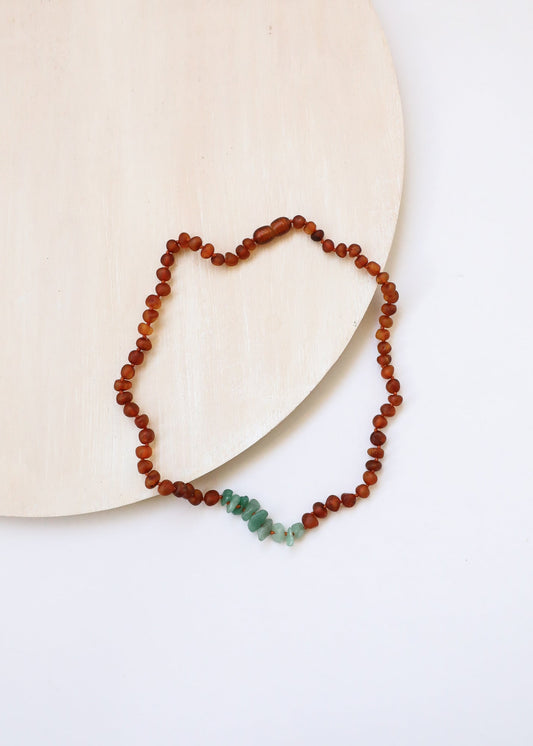 Raw amber bead necklace with green aventurine chip accents, heart-shaped drape