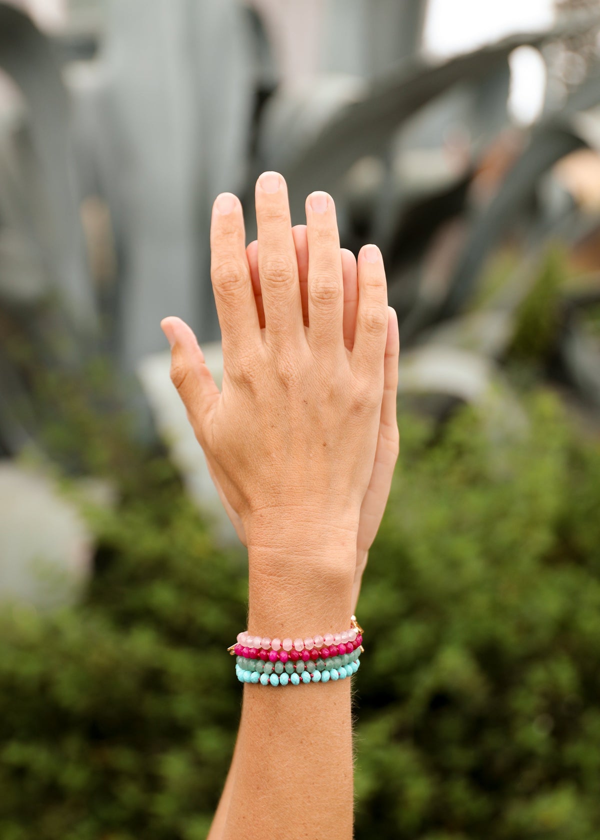 Stacked multicolor gemstone beaded bracelets on wrist