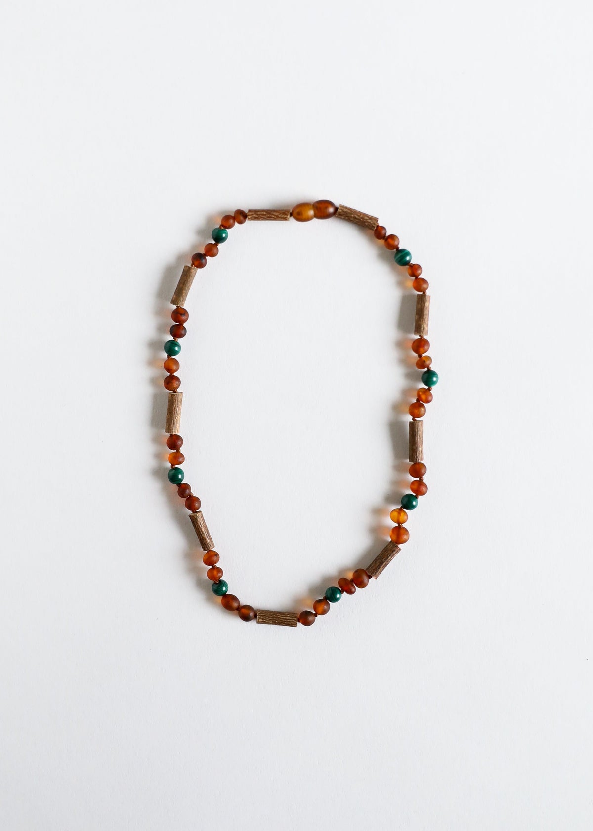 Amber and malachite bead necklace, dark brown cylindrical beads with teal highlights