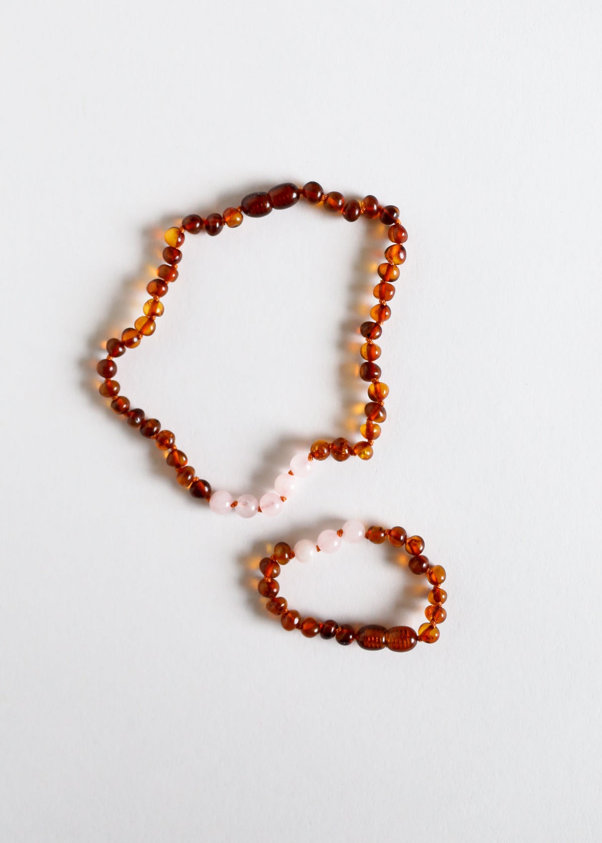Amber bead necklace with pink rose quartz accents plus matching bracelet