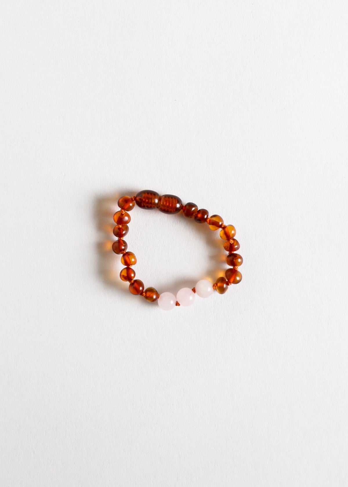 Polished cognac amber beaded bracelet with white rose quartz accents
