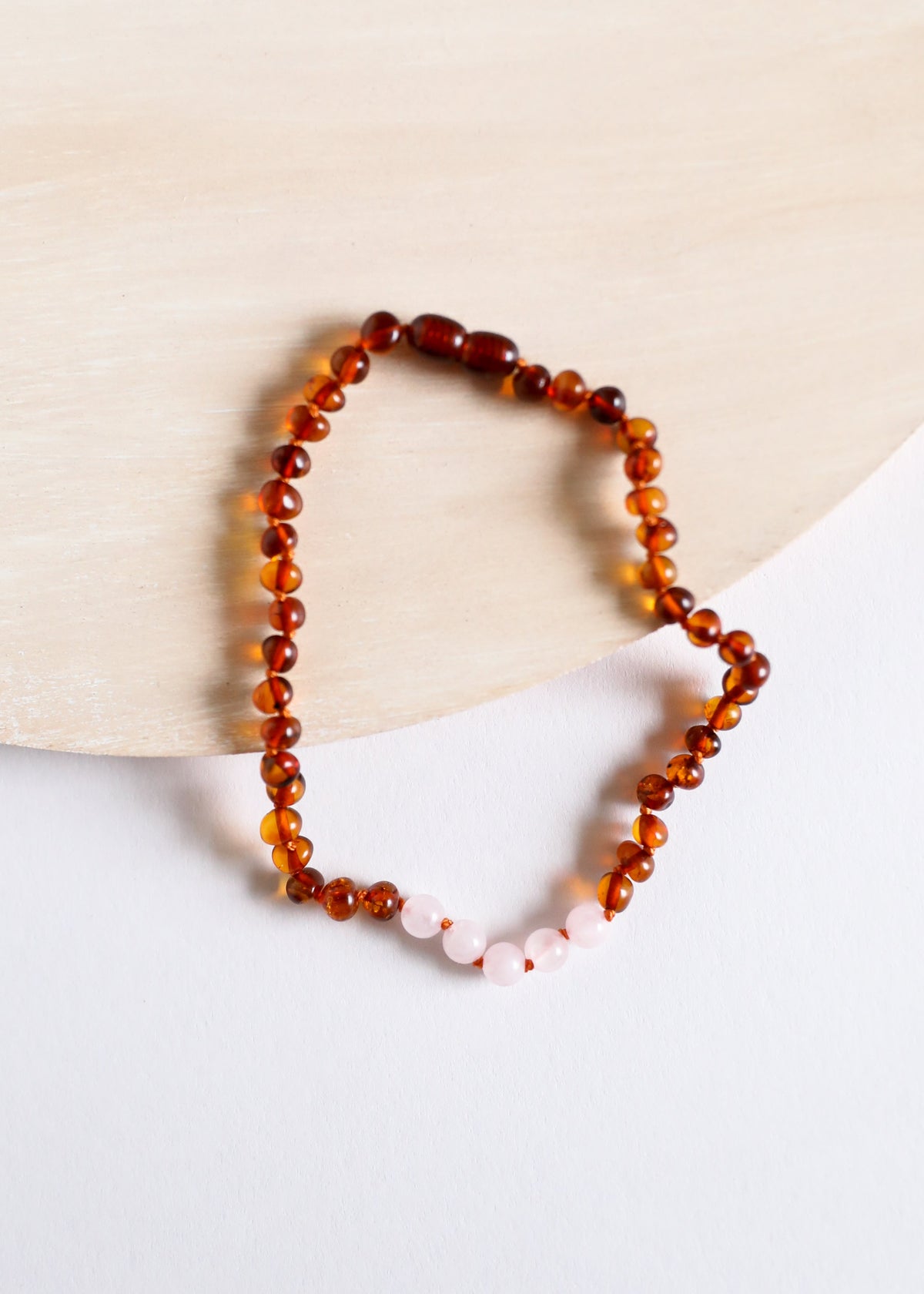 Amber bead necklace with pink rose quartz teardrop details