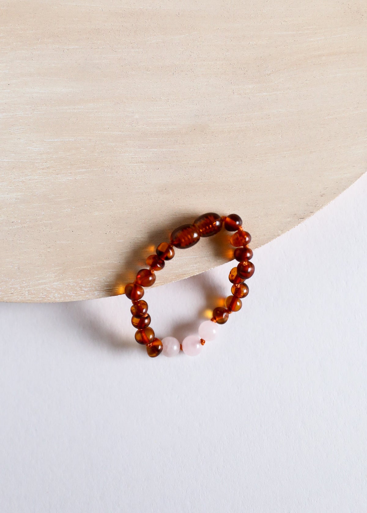 Cognac amber bead bracelet with white rose quartz stone detail