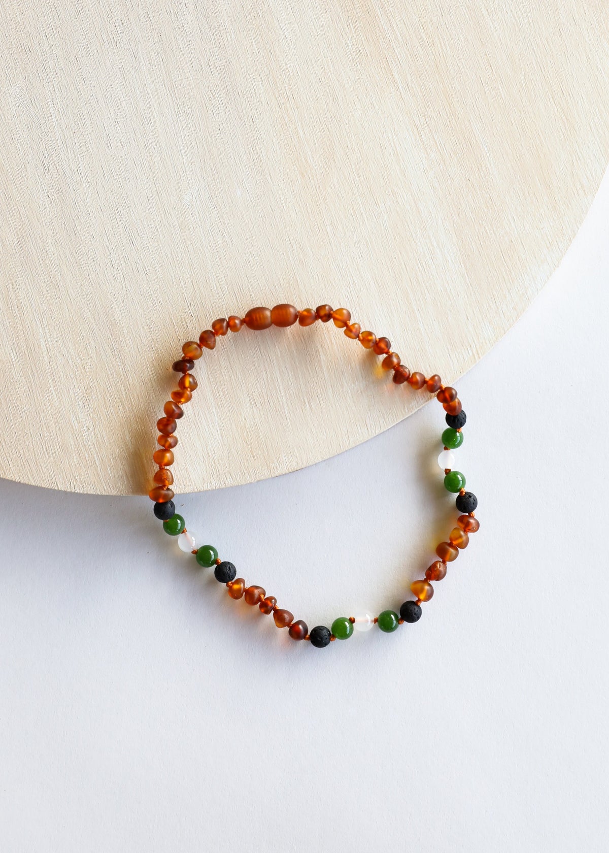 Beaded necklace strand with cognac amber orange, green and dark beads