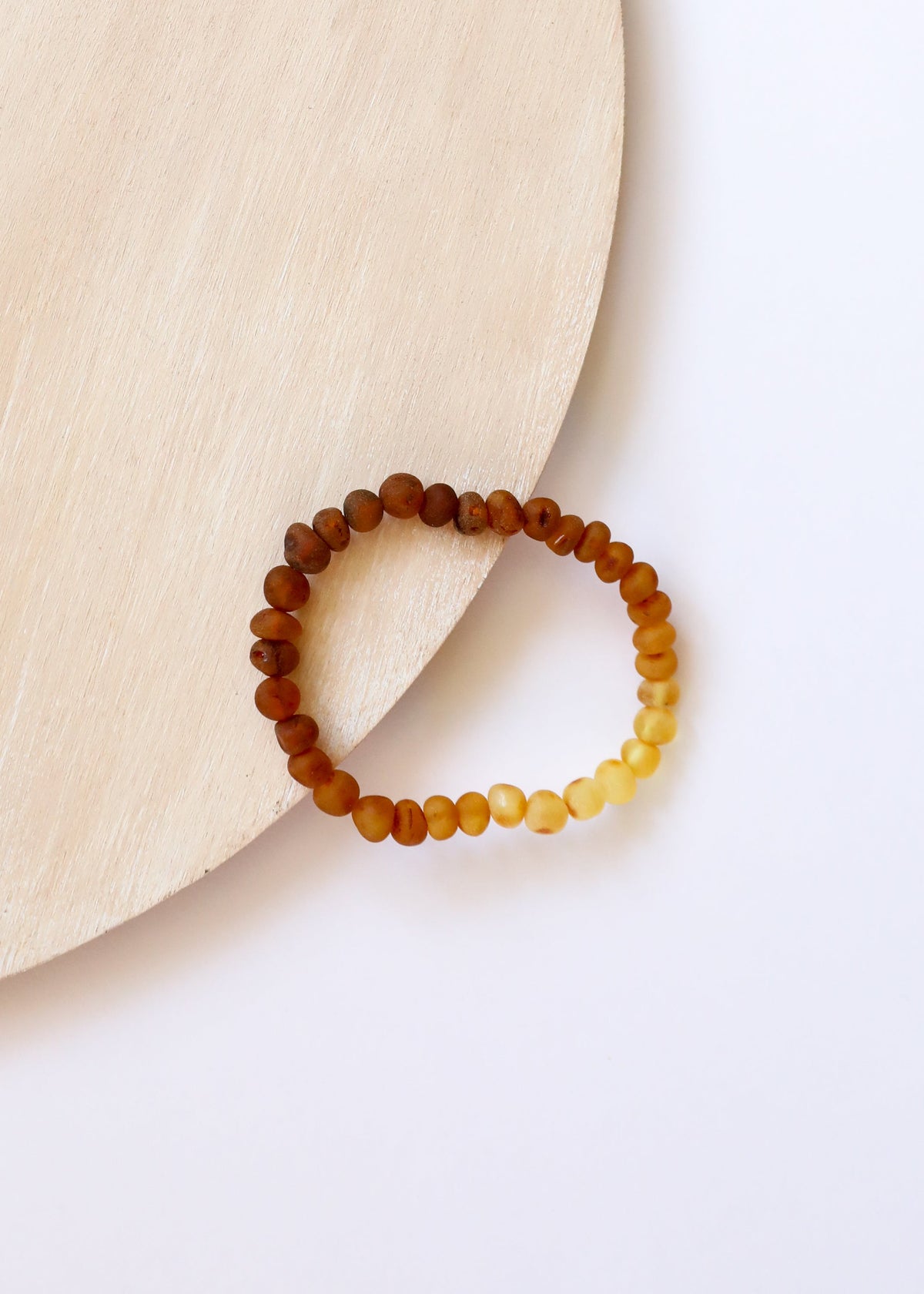 Two-tone amber beaded adult bracelet with dark brown and honey-yellow beads