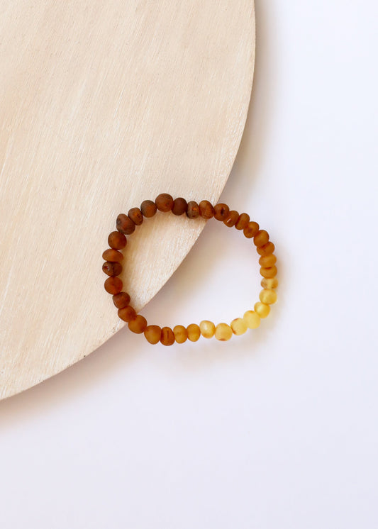 Two-tone amber beaded adult bracelet with dark brown and honey-yellow beads