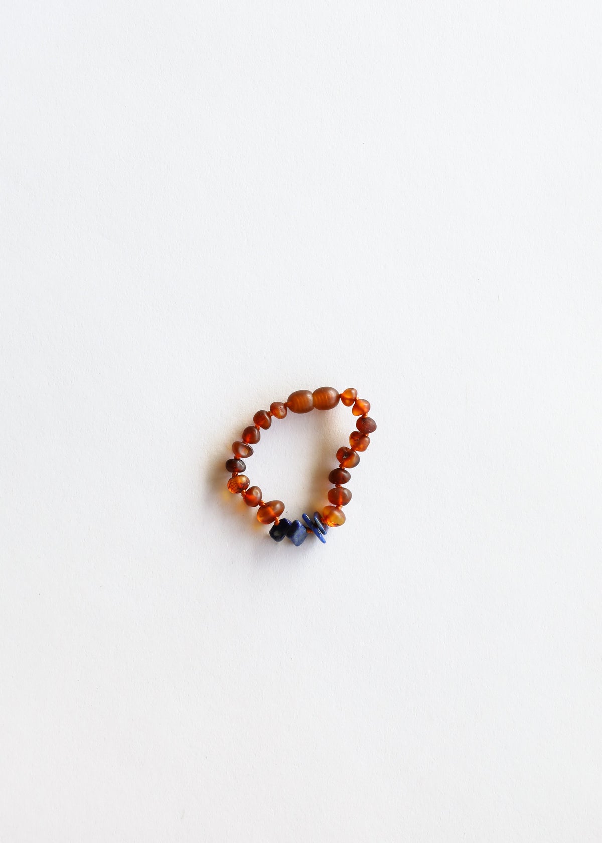 Cognac amber and lapis lazuli beaded bracelet with orange beads and small blue charm