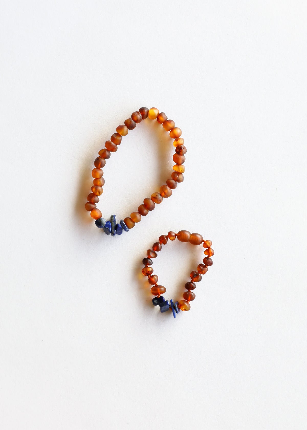 Cognac amber and lapis lazuli beaded bracelet set with two orange bead cuffs